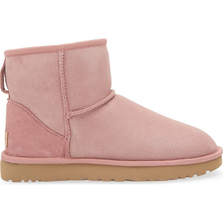 Pink suede boot on a white background
