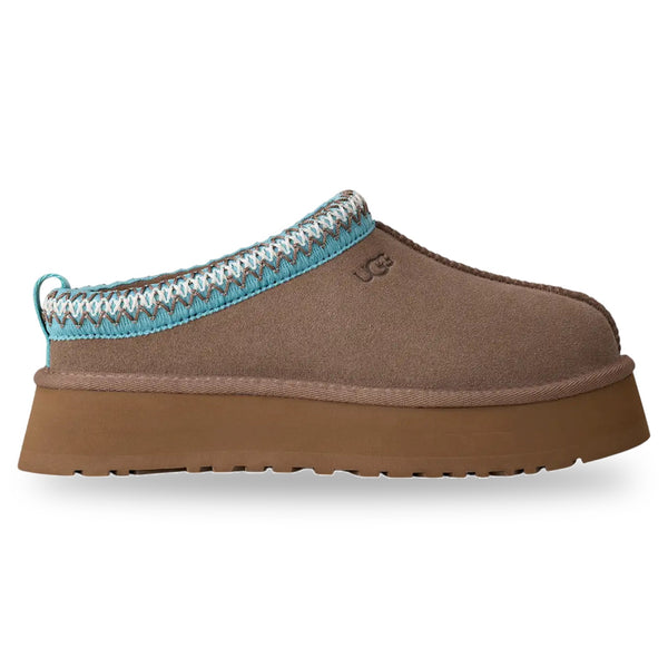 Brown slipper with a blue and white crocheted trim on a white background