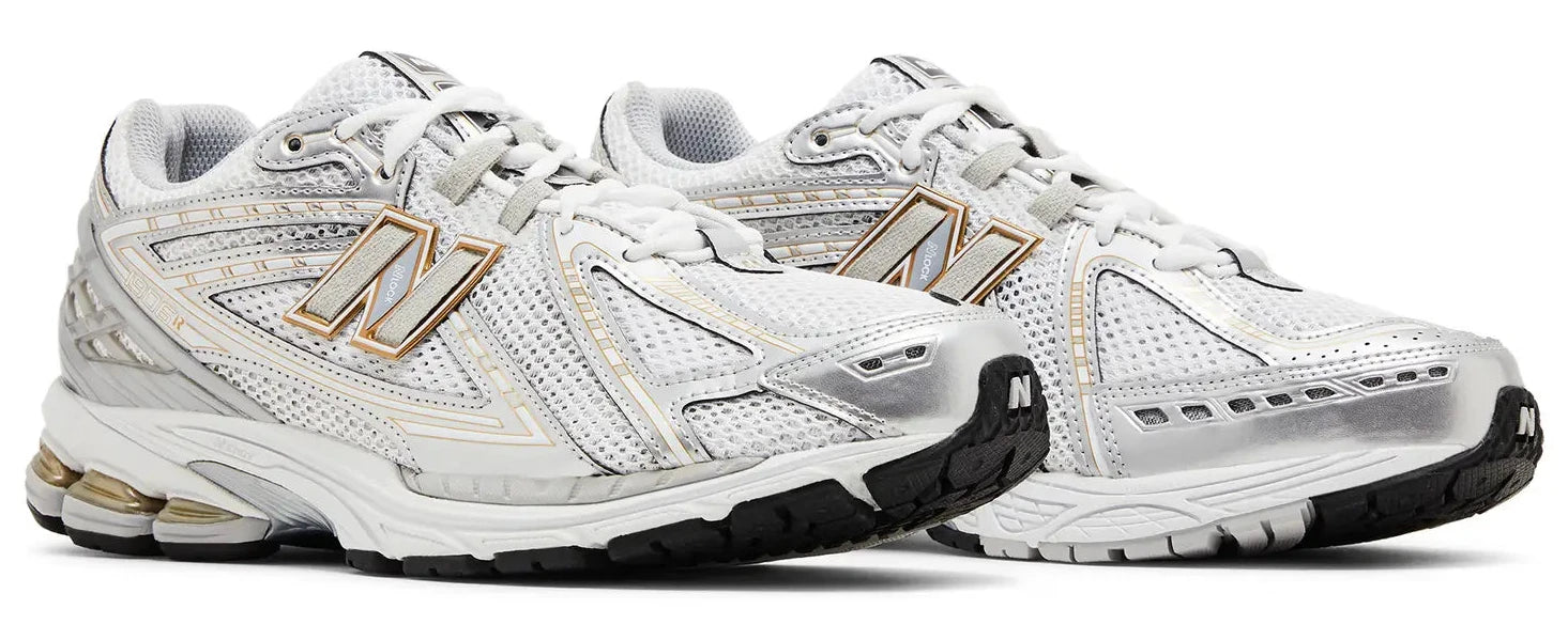 White running shoes with gold accents on a white background