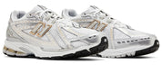 White running shoes with gold accents on a white background