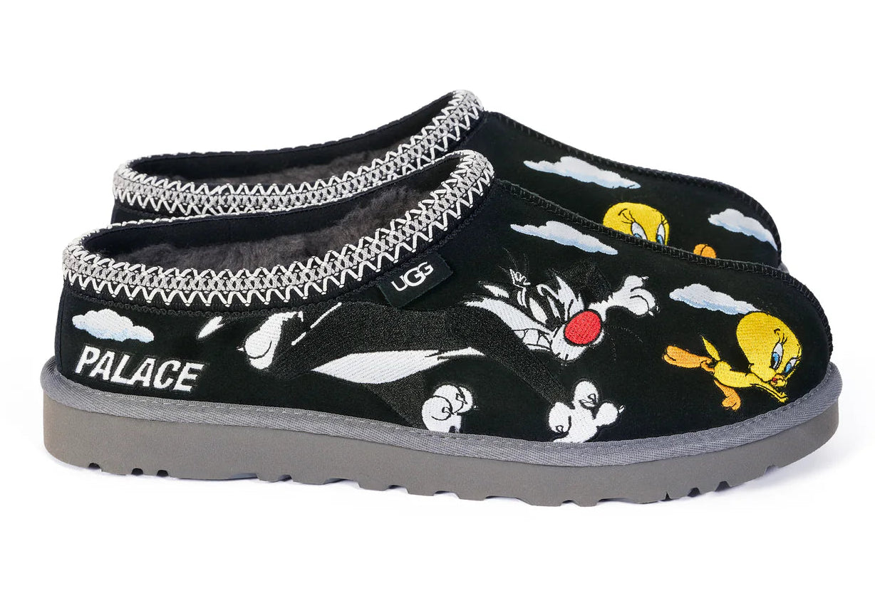 Black slippers with cartoon character design and 'Palace' branding on a white background