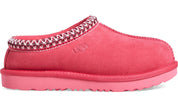 Pink slipper with decorative trim on a white background