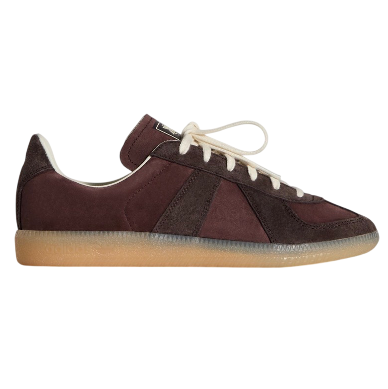 Brown sneaker with white laces on a light gray background