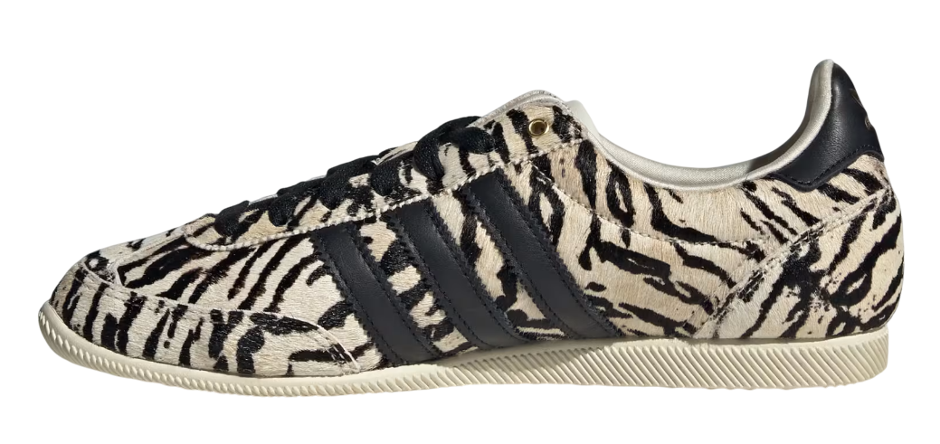 Sneaker with zebra pattern and three black stripes on a white background