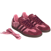 Pink and maroon Adidas sneakers with matching laces on a white background