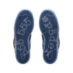 Close-up of the soles of a pair of shoes with a white background - Image 5