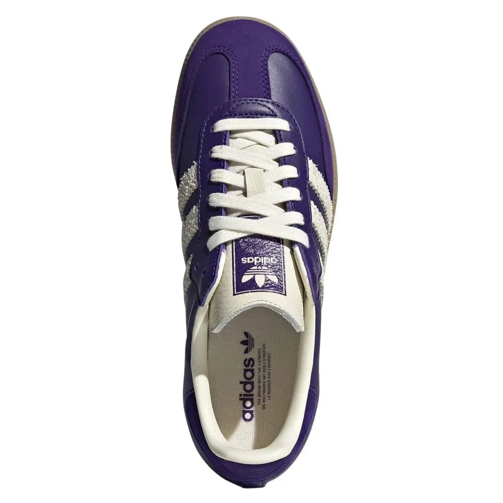 Purple Adidas sneaker with white laces on a white background