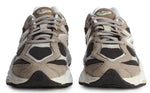 Pair of beige and black sneakers on a white background - Image 4