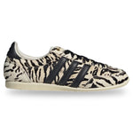 Zebra-patterned sneaker with black stripes on a white background - Image 1