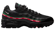 Black sneaker with red and green stripes on a white background