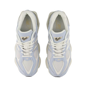 Pair of light blue and white sneakers on a white background