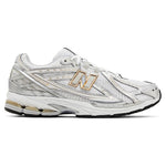 White athletic shoe with gold accents on a white background - Image 1