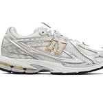 White athletic shoe with gold accents on a white background - Image 1