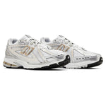 White running shoes with gold accents on a white background - Image 3