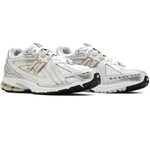 White running shoes with gold accents on a white background - Image 3