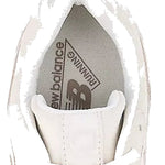 White sneaker with New Balance logo on a light gray background - Image 3