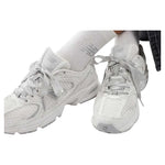White sneakers worn with white socks on a white background - Image 5