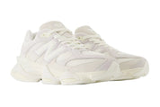 Pair of white sneakers on a light gray background