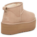 UGG Classic Ultra Mini Platform Boot Sand (Women's) — rear three-quarter, UGG logo heel - Image 4